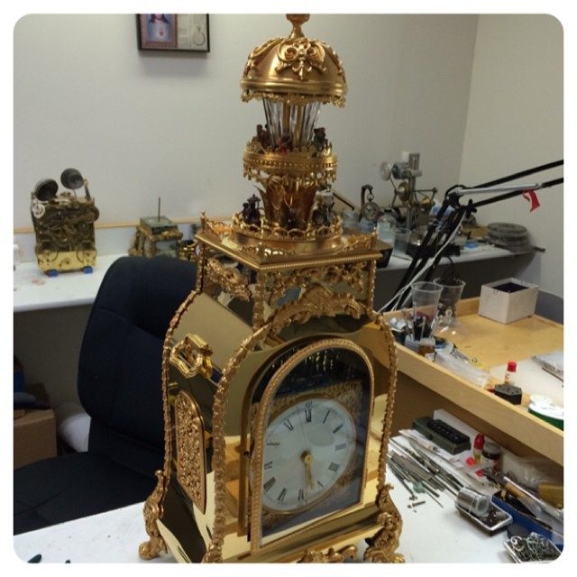 this is a wood clock we wrapped in brass and bronze and plated in 24k gold - 5 month project done.